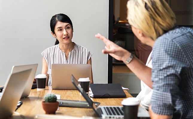 Professionals in Sydney office discussing their government website project