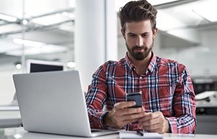 Professional woman using mobile device to visit an ecommerce website