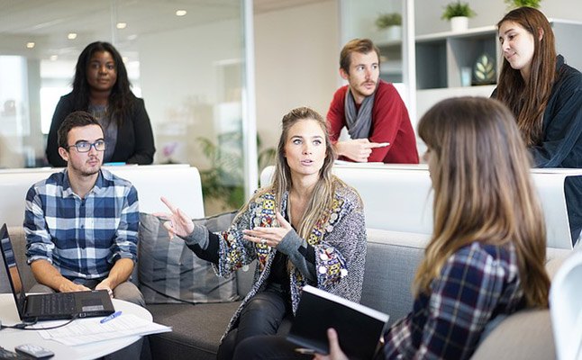Professionals in Sydney office discussing a UX brief