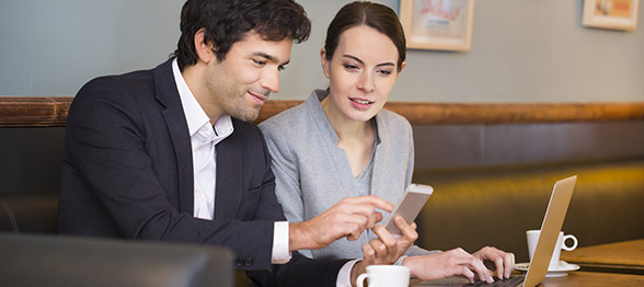 Business man and woman viewing mobile phone