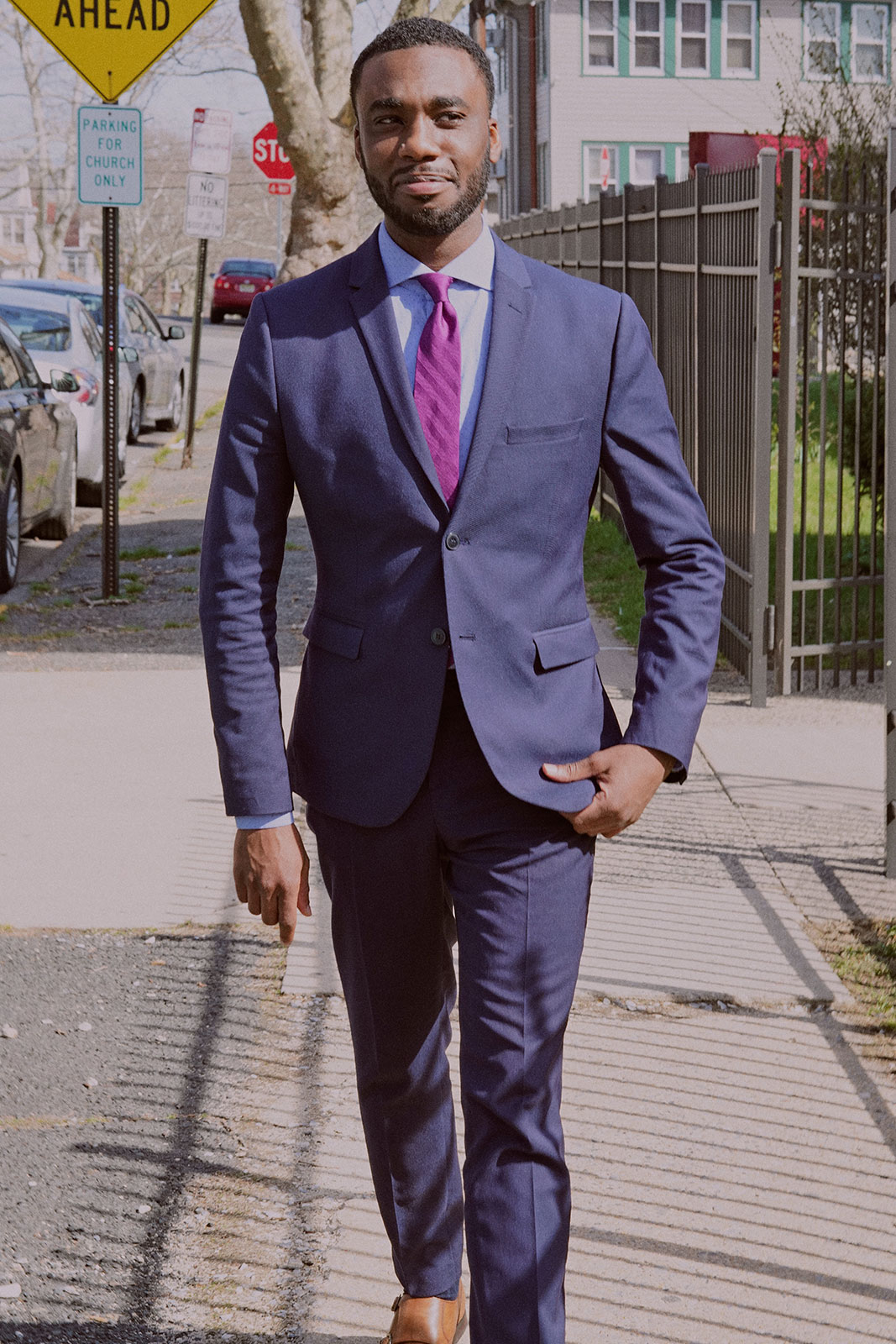Professional man in suit walking outside and smiling
