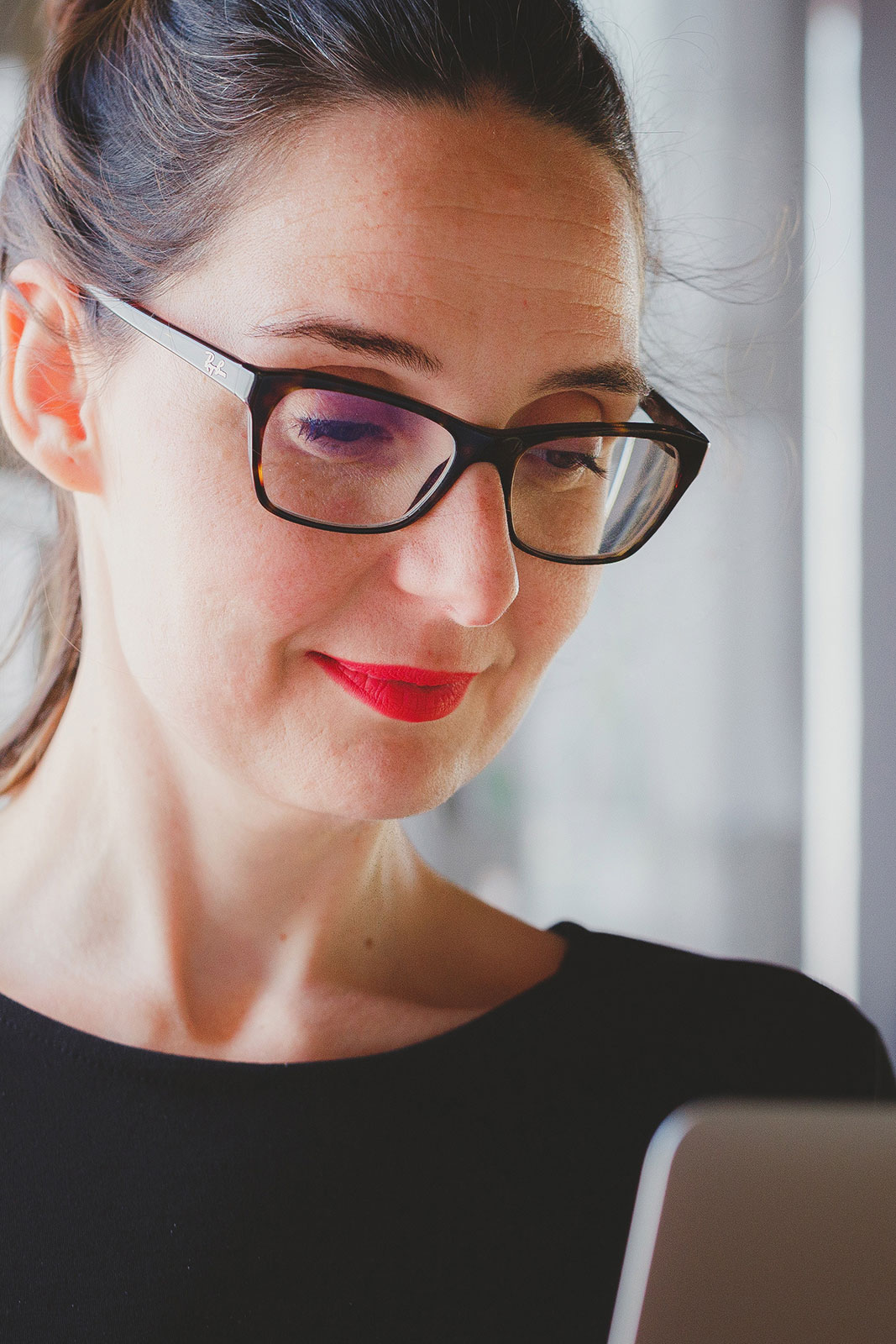 professional woman smiling at her computer