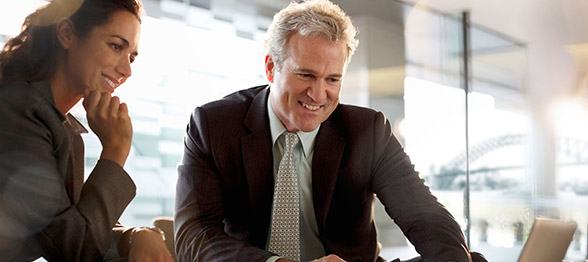 Mature business professionals viewing laptop