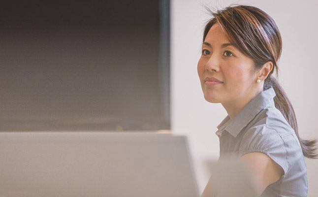 Professionals in Sydney office discussing a business case