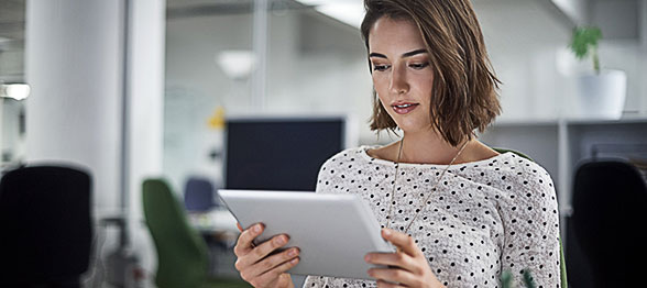 Young professional woman using tablet device
