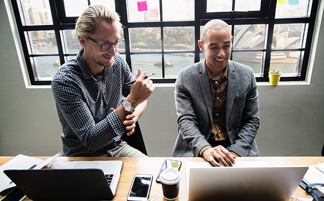Professionals in Sydney office discussing a business case