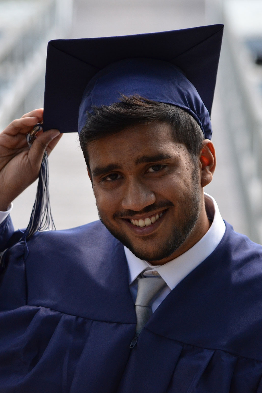 13. Graduate student smiling with gown on
