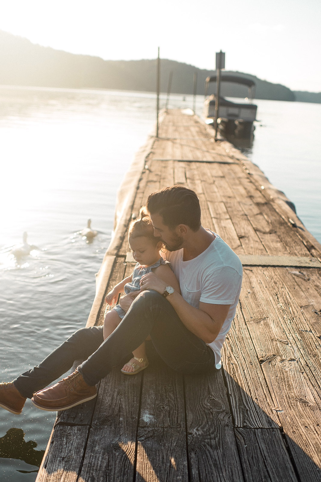 Father with his child on a lake on a sunny day