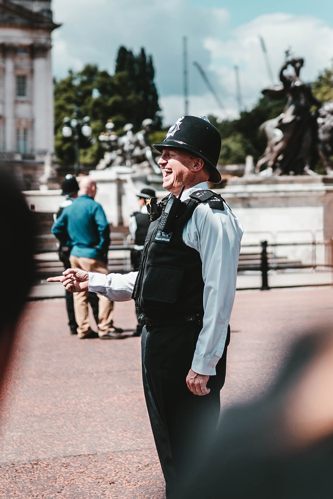 Police offer smiling and standing outside on a sunny day
