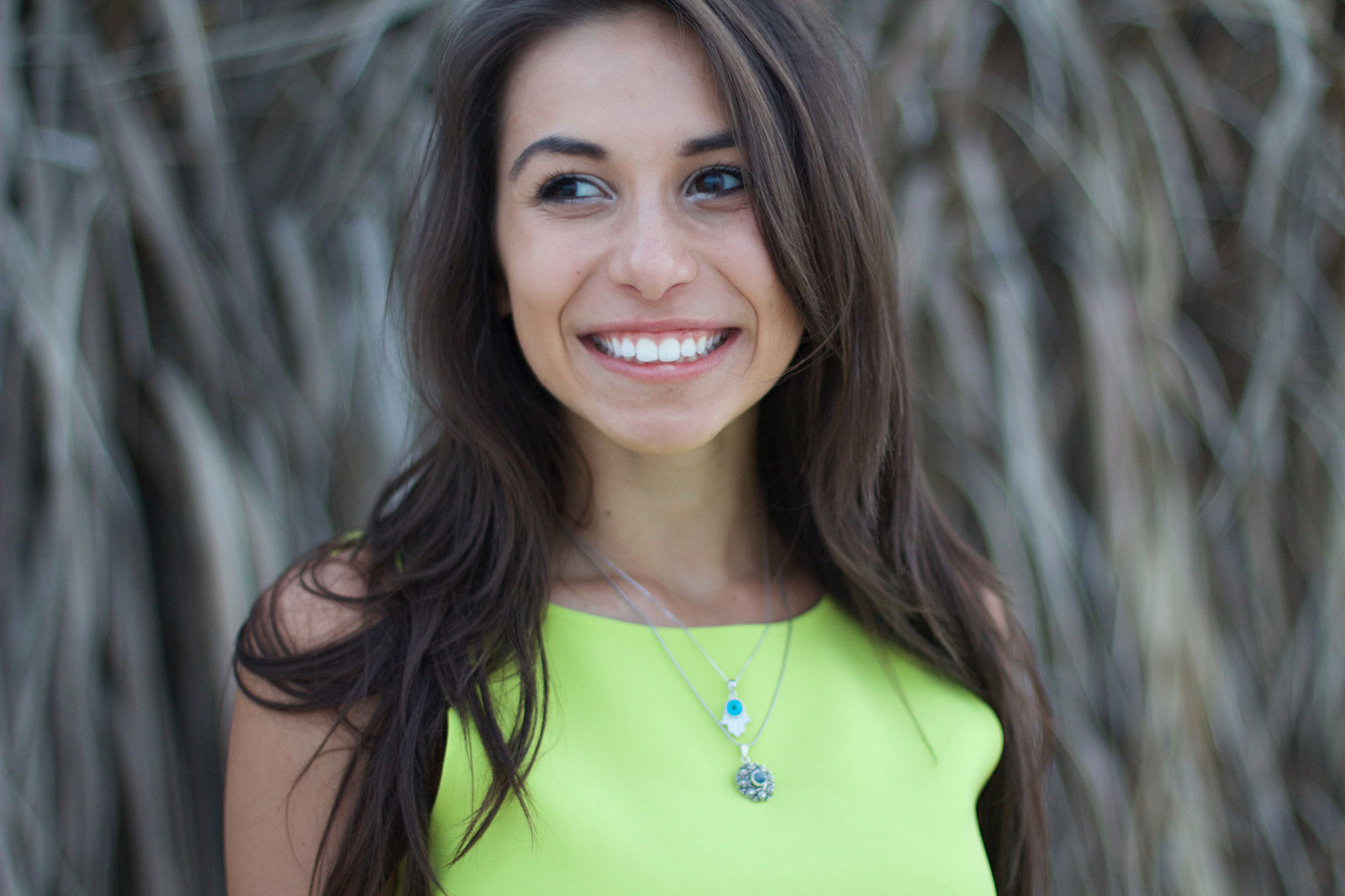 Young woman smiling outside